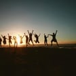 Happy People jumping on sunset