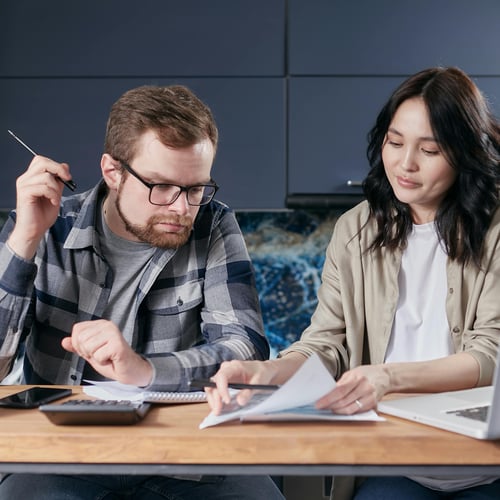 Couple looking at cost of buying alone