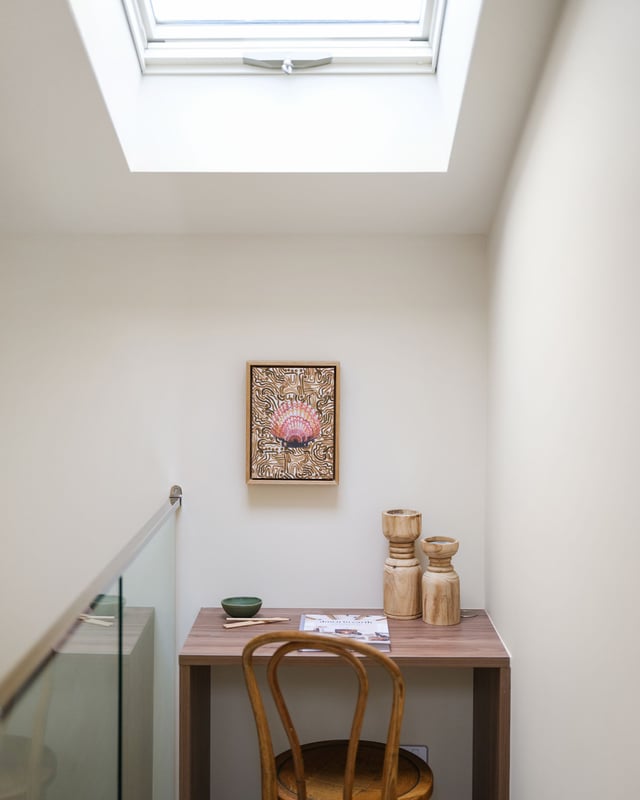 Skylit study nook beside the stair void