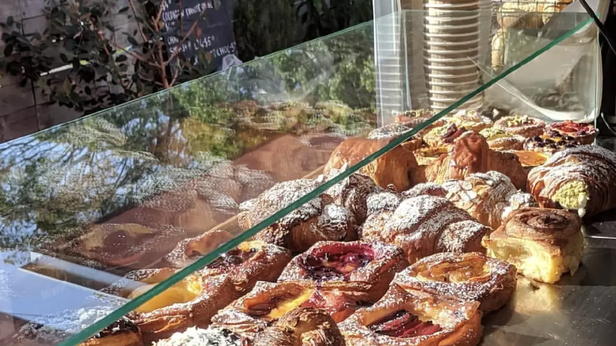 Red Bootleg Bakery van on James St, Merewether, with trays of croissants and danishes.